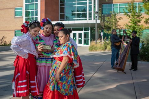 Members of the Weber State University Ballet Folklórico group watch a video of a past performance during a community event celebrating Hispanic Heritage Month at Weber State on Sept. 30. Photo credit: Weber State University