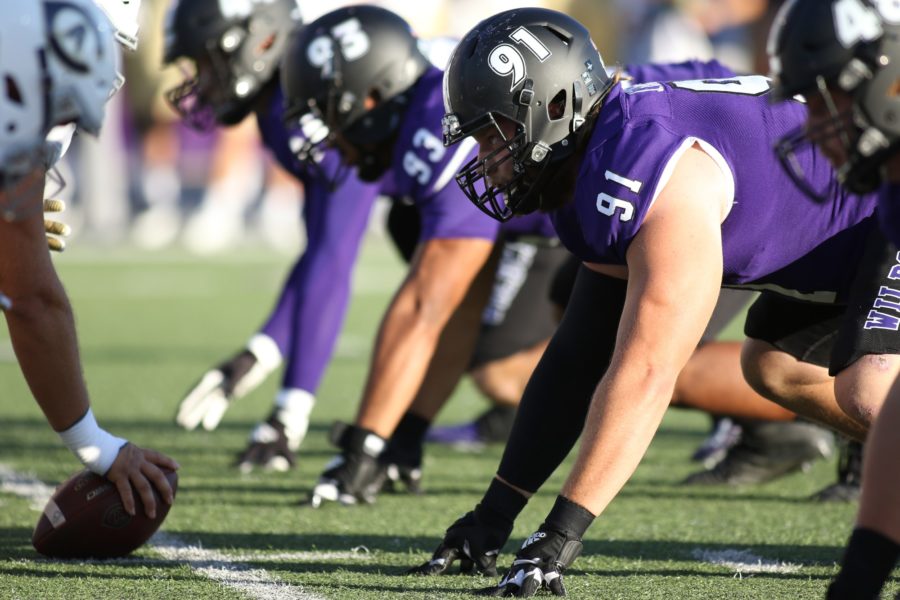 Wildcat defensive lineman Jared Schiess, 91, and Sione Lapuaho, 93, prepare for the snap at Stewart Stadium on Sept. 25. Photo credit: Robert Casey / Weber State Athletics