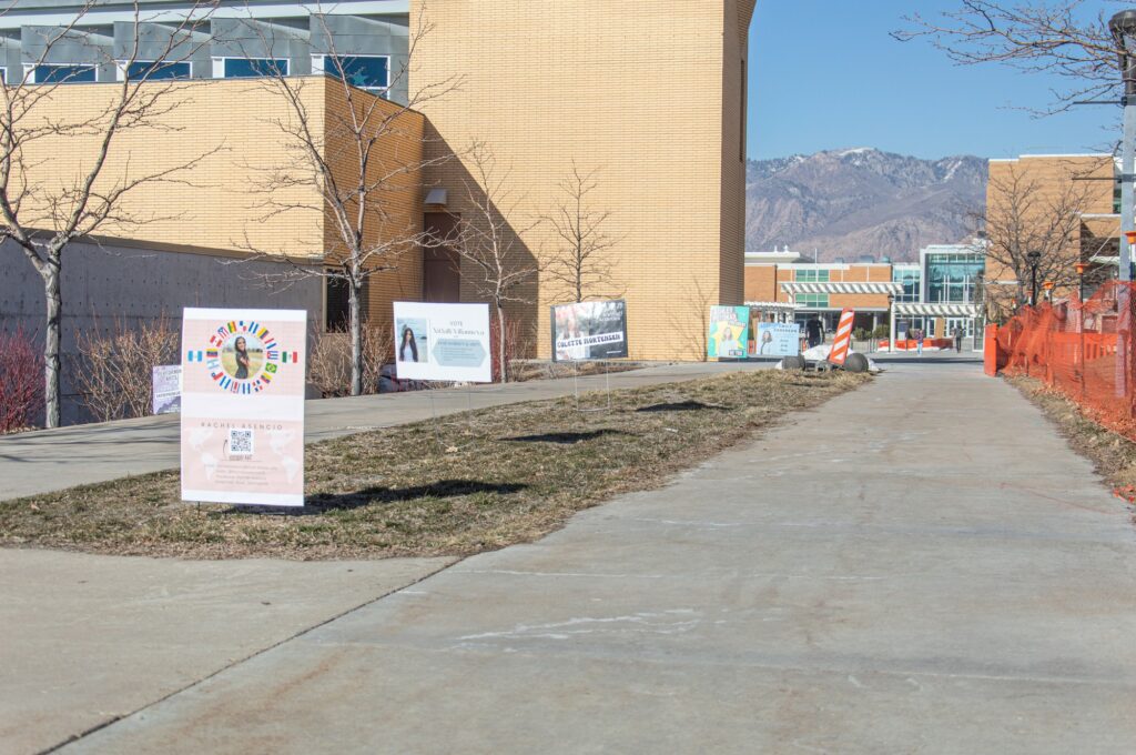 Advertisements for the running senators placed in a row in front of the W8 parking lot, located on Ogden campus. (Kennedy Robins/ The Signpost)