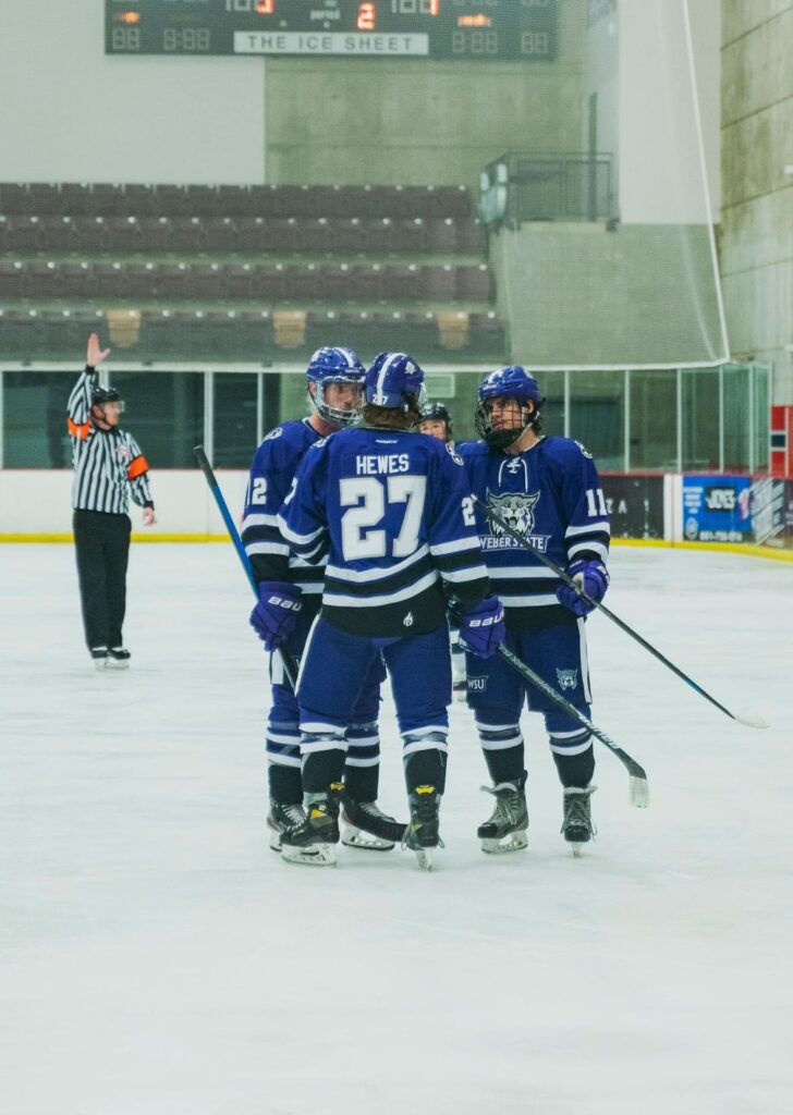 Jaden Hewes, Will Fobair and Cole VanOrman gather between play.