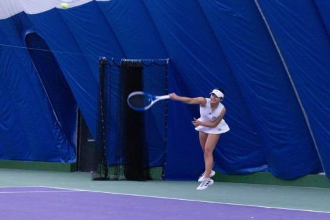 Yuuna Ukita twisting her arm around in order to achieve hitting the tennis ball she just hit. (Kennedy Robins/ The Signpost)