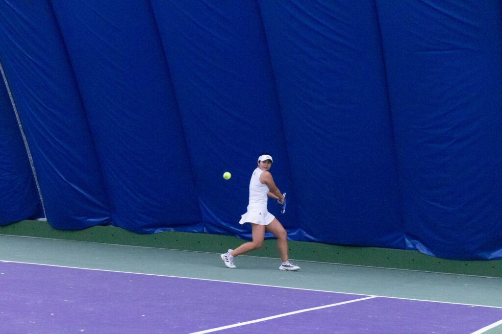 Preparing to hit her tennis ball, Yuuna Ukita pulls her racket back. (Kennedy Robins/ The Signpost)