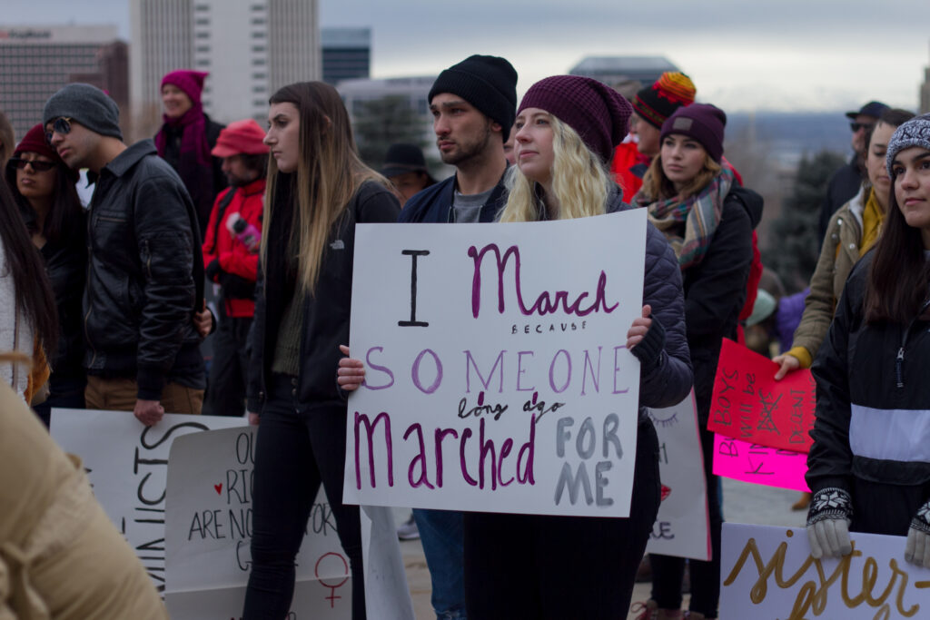 Women looked on, holding their signs as many recited chants in front of the capitol building during the 2019 Women's March (The Signpost Archives)