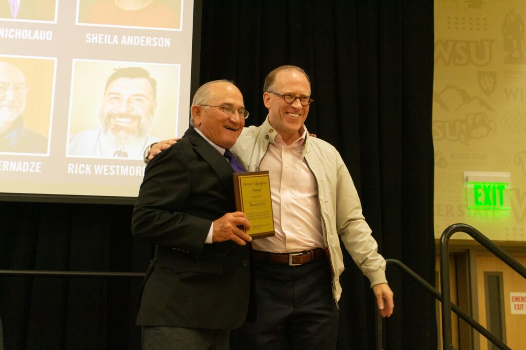 Winn Stanger and Tim Eck posing for a picture after giving and receiving a career champion award. (Kennedy Robins/ The Signpost)