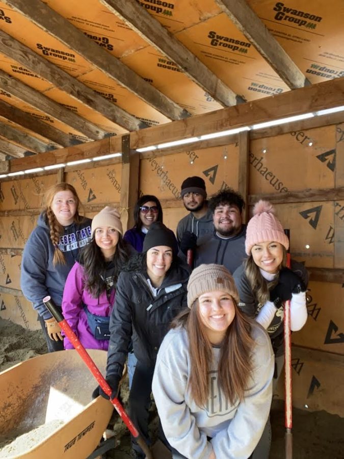Weber Students are seen cleaning up and prepping the new goat shelter. Photo credit: Zadoth Vazquez