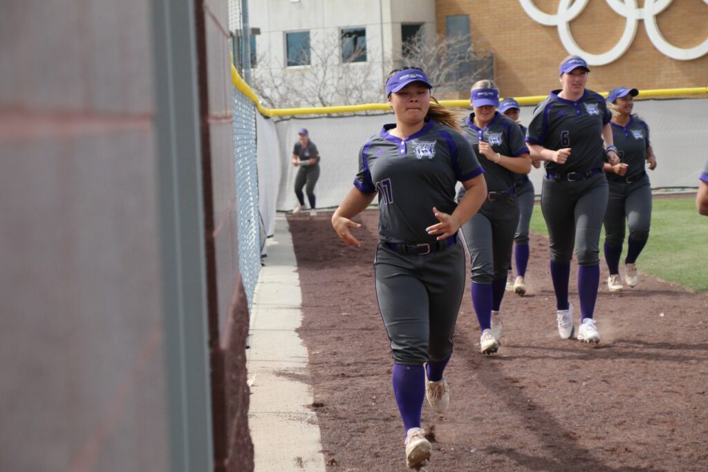 Mika Chong runs toward the dugout after a warmup between innings. (Summer Muster/The Signpost)