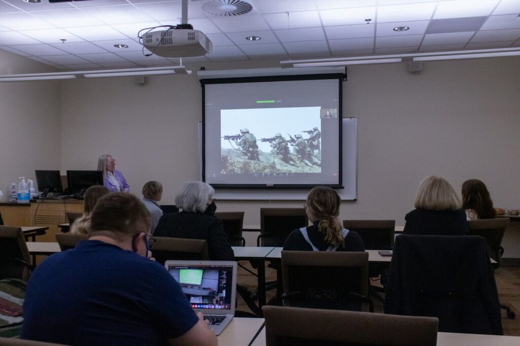 Lynsey Addario showing a classroom full of people her photos of war. (Kennedy Robins/ The Signpost)