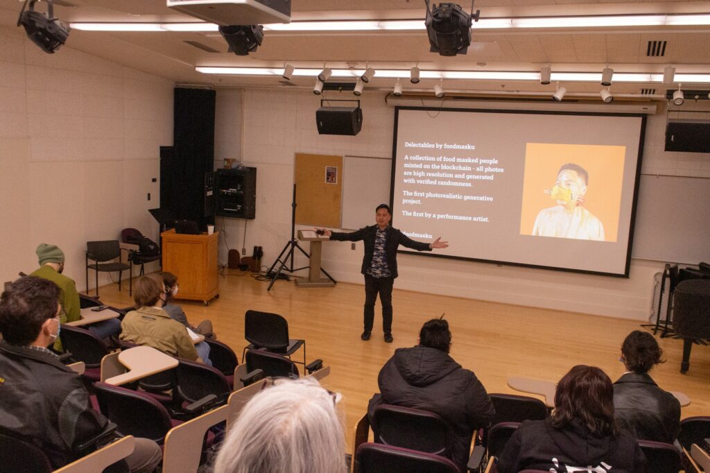 The audiences point of view of Antonius Oki and his art shown on a projector screen. (Kennedy Robins/ The Signpost)