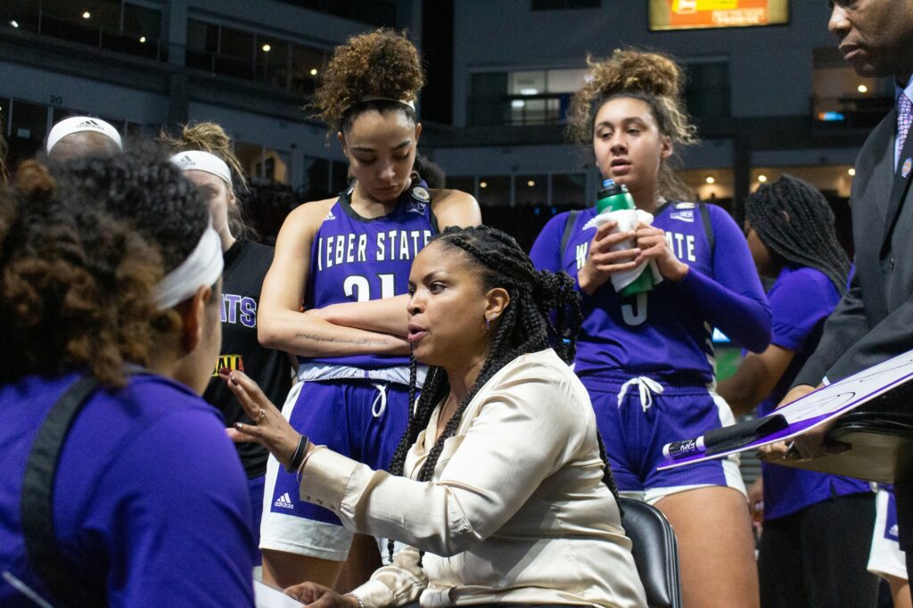 Head coach Velaida Harris preps her team during a time out. (Kennedy Robins/ The Signpost)