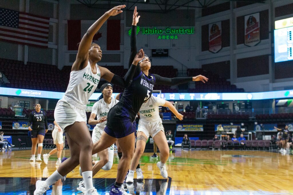 Jadyn Matthews reaching to grab a basketball falling after being thrown at the basketball hoop. (Kennedy Robins/ The Signpost)