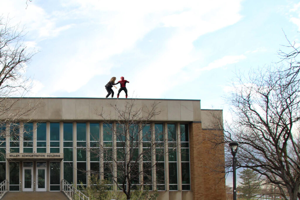 Tom Holland and Zendaya run across the Miller Admin Building.