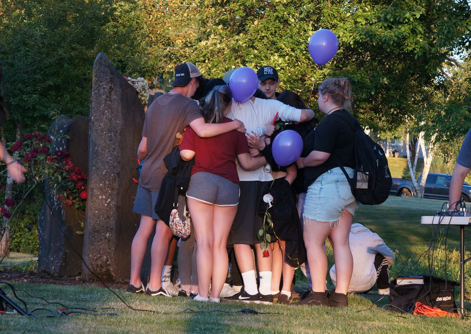 Community members gather at Estacada High School for a candlelight vigil June 2, 2021 to mourn the loss of three teenagers in a Memorial Day car crash.