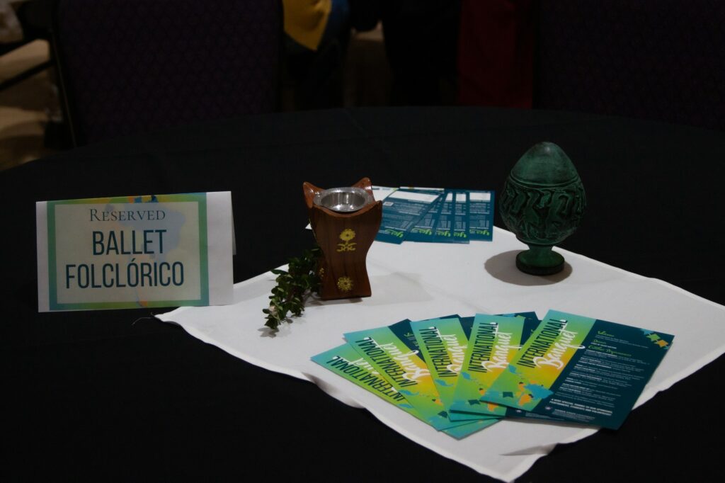 The tables in the event are set with centerpieces representing different cultures, as well as some signs reserving a place to sit for the performers. (Bella Torres / The Signpost)