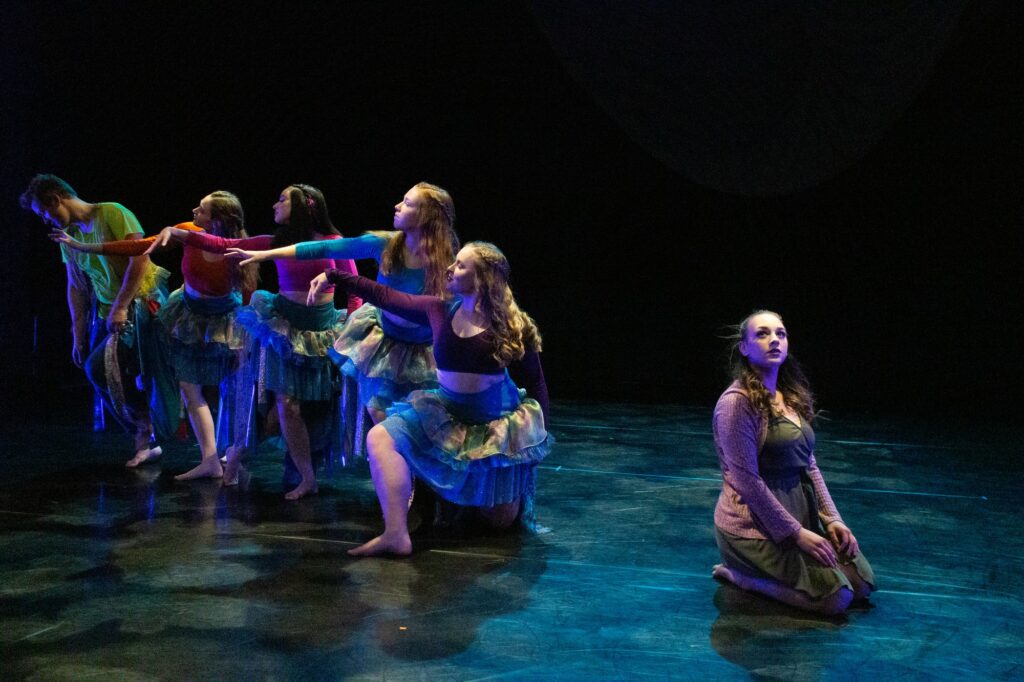 Orchesis dancers outstretching their arms while dancing in "Unconscious Caged Mind."