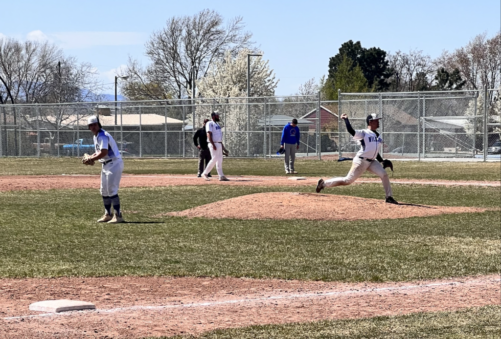 Wade Rodgers pitches as the infield sets up for the play.