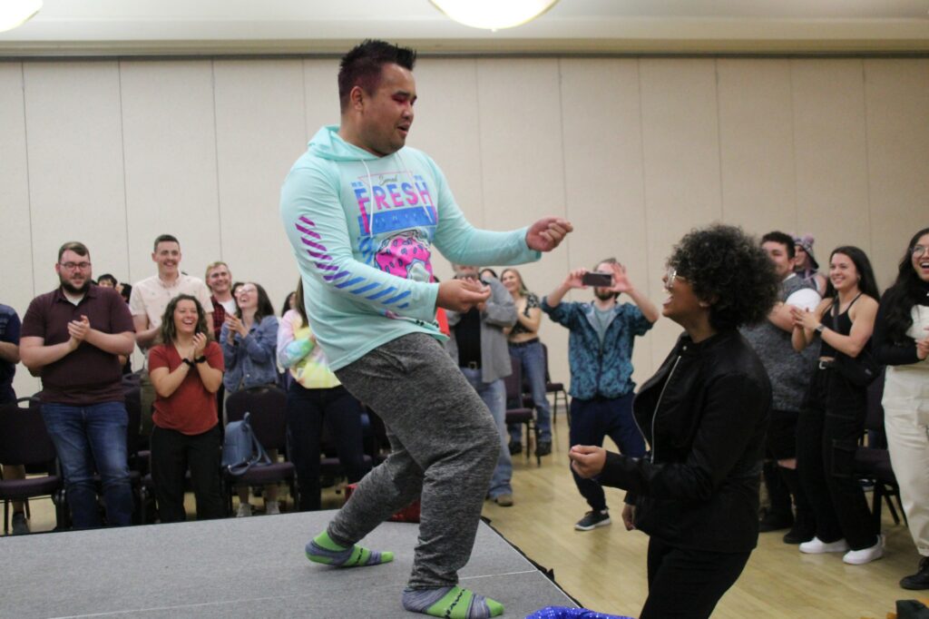 Psi Phy (left) dances with Marjorie Maharaj (right) as the audience cheers and claps. (Summer Muster/The Signpost)