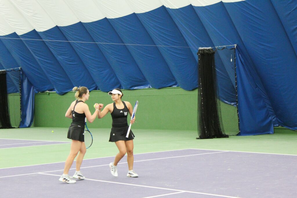 Comunicatiopn is key within the tennis doubles matches. throughout the game you can hear them yell towards each other in suport and with instruction. (The Signpost / Hannah moore)