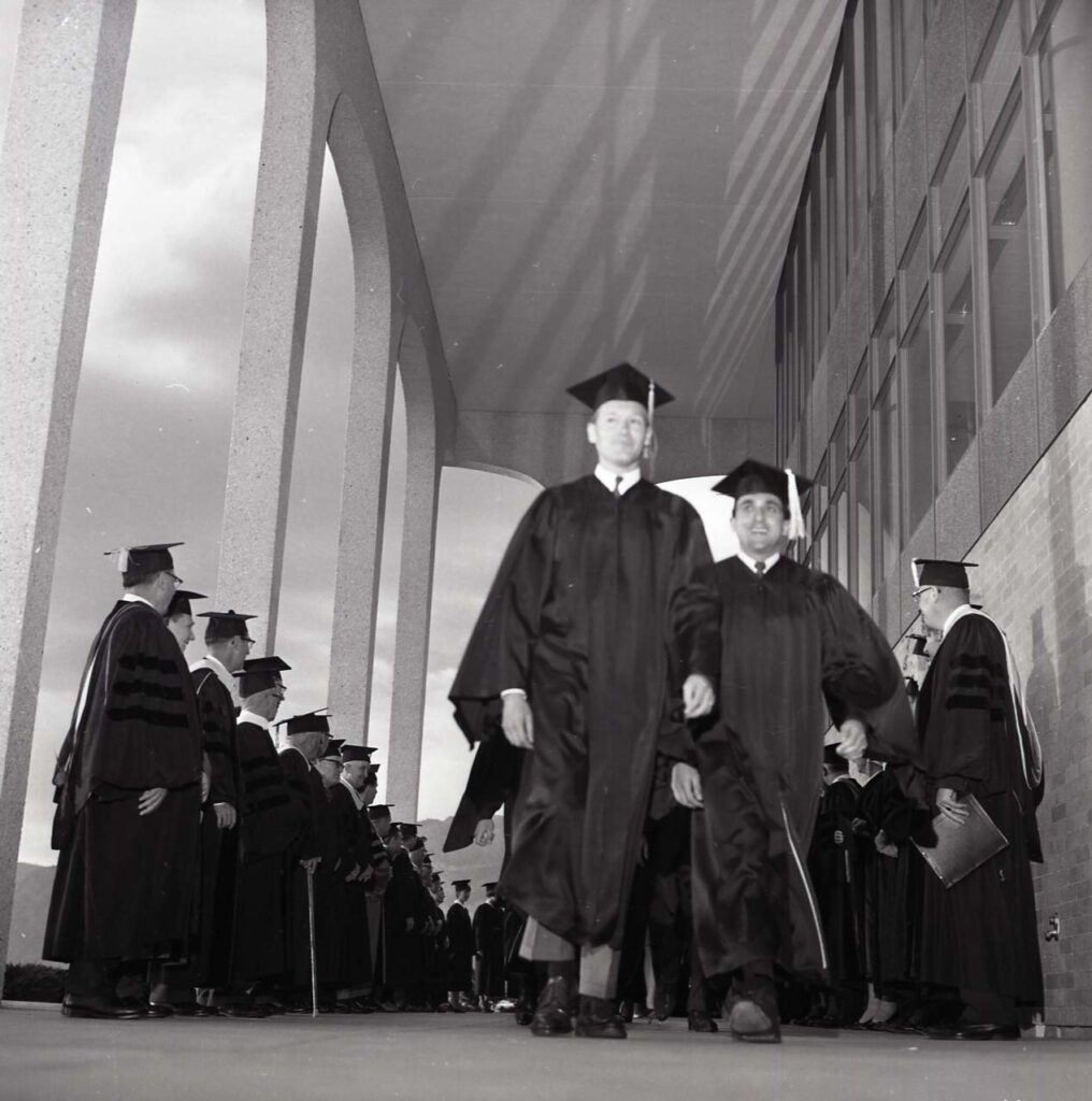 Previous Weber State grads walking towards their ceremony. (Weber State University)