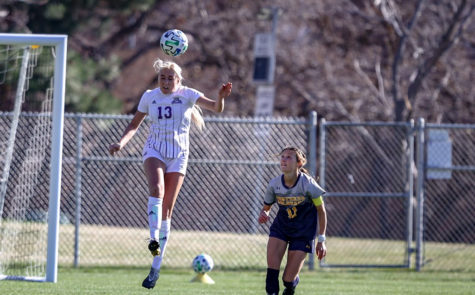 Hailey Price bumps a soccer ball off her head during a game against UNC in 2021.