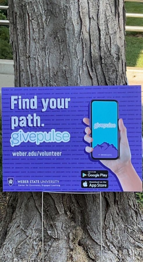 A picket sign of the GivePulse app on campus.