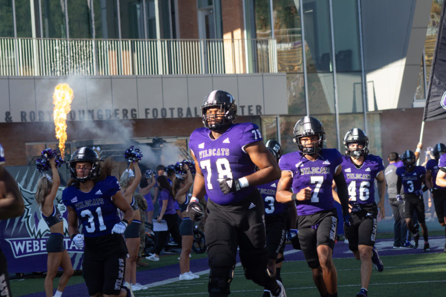 Chinonso Opara leading the WSU football team out of the tunnel and onto the field during their game with Western Oregon on Sept. 1.