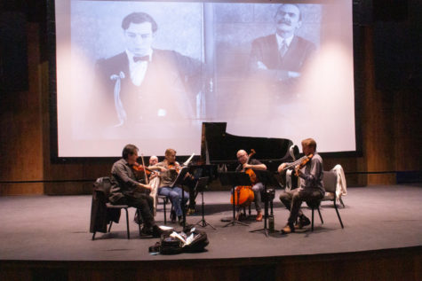 The Fry Street Quartet rehearses while a movie known as College plays in the background in the Browning Center building.