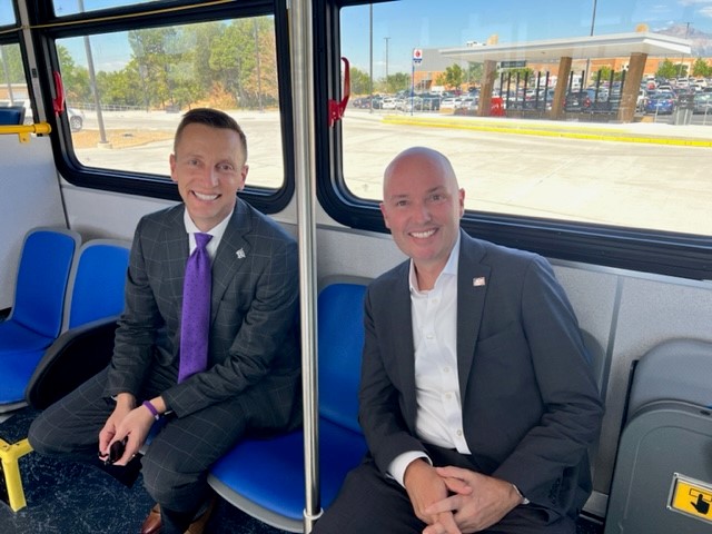Governor Cox and President Mortensen riding on the new UTA bus shuttle on campus. (James Larson)