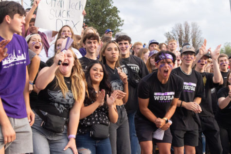 WSU football fan Isaac Staszkow (right of middle) cheering on the Weber State football team along with the rest of the student section.