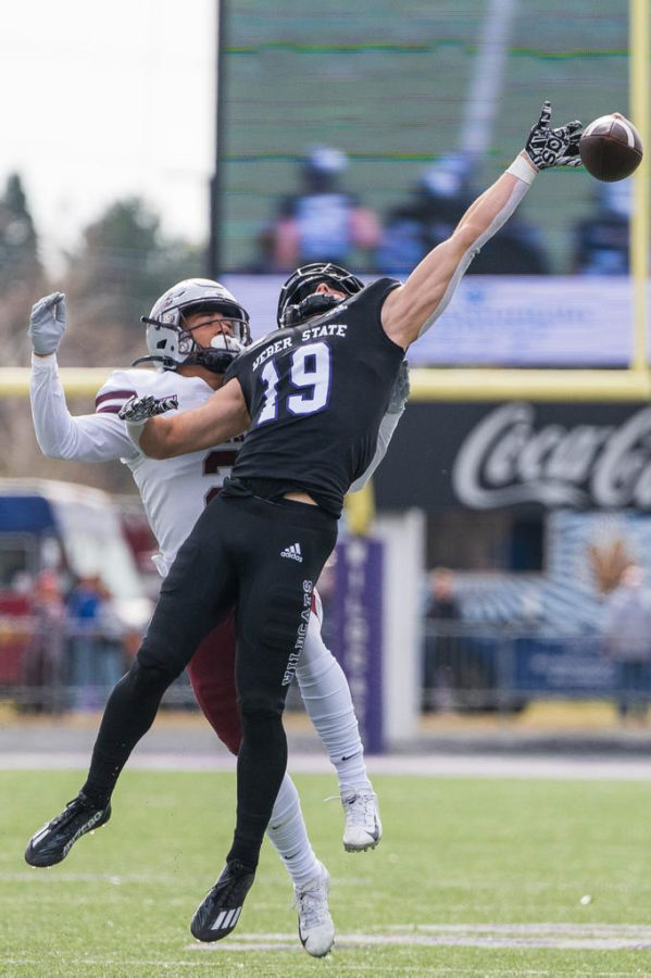 Jon Christensen (19) of the Weber State Wildcats reaches for a pass as Jayden Dawson (2) of the Montana Grizzlies looks on during their game at Stewart Stadium on Oct. 22.