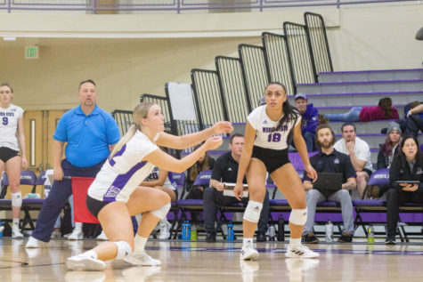 Outside Hitter Dani Richins (12) right after hitting a volleyball while Outside Hitter Jayda Tupea (18) watches where the ball lands.
