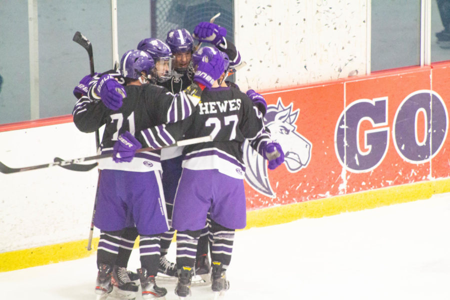 The Hockey team huddles together after making their first goal in their game against MSU Denver.