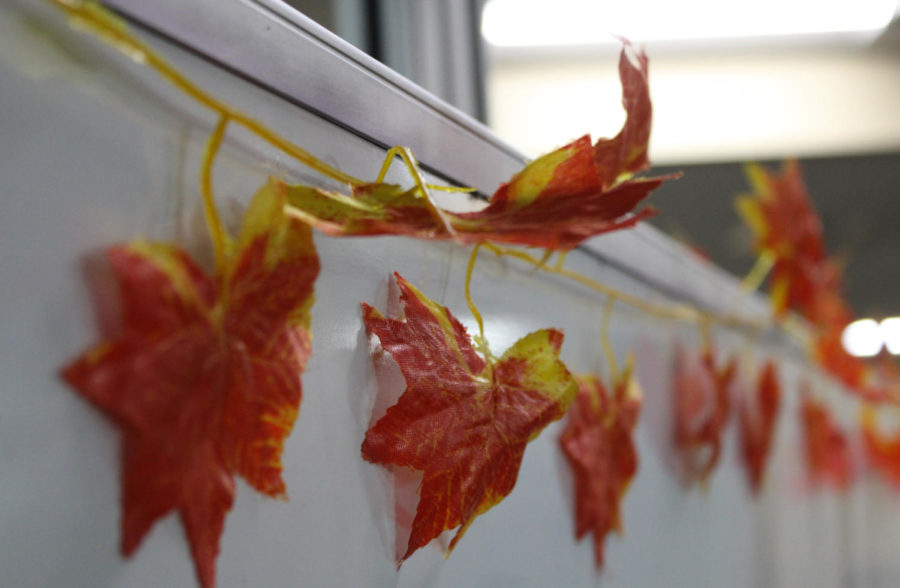 A leaf garland bordering a whiteboard outside the Department of Student Involvement and Leadership office in Shepard Union.
