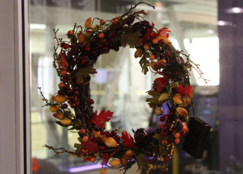 A festive Autumn wreath hanging on the entrance door to the Department of Student Involvement and Leadership.