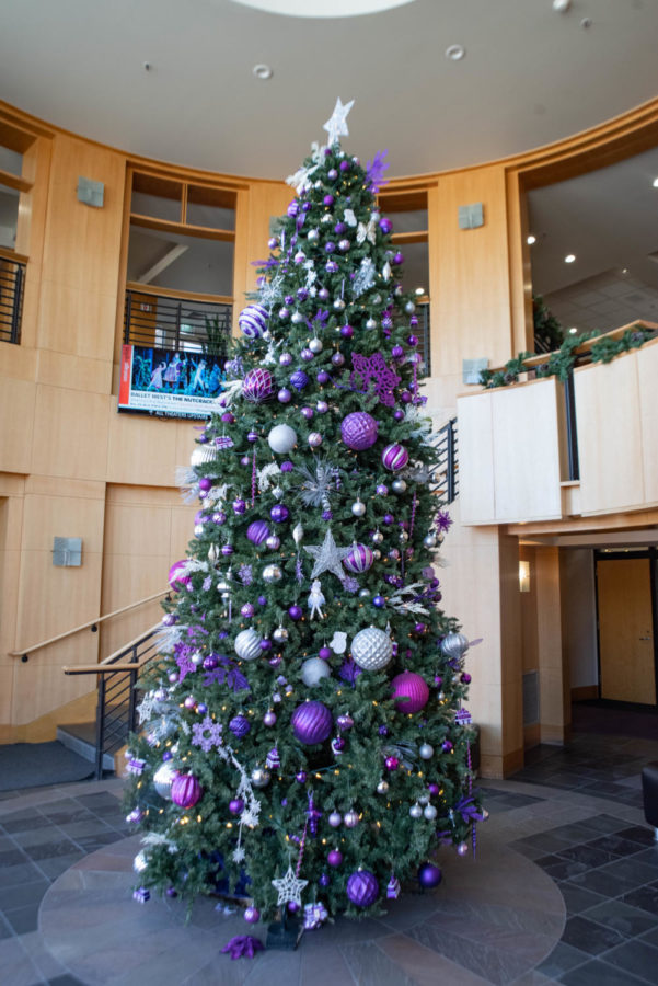 A Christmas tree at Weber State, decorated in purple and white ornaments.