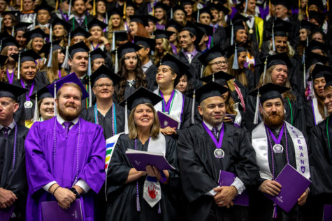Students receiving their diplomas at their graduation ceremony.