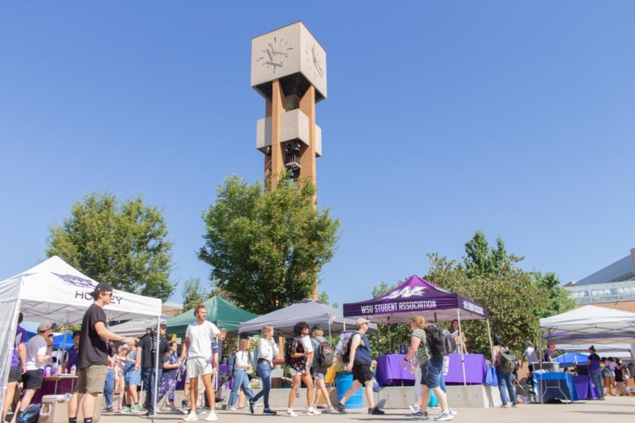 Students walking around the clock tower during the 2022 block party.