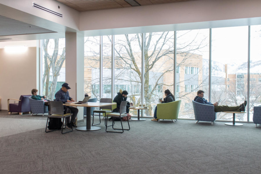 Students sitting in chairs to study in the Stewart Library.