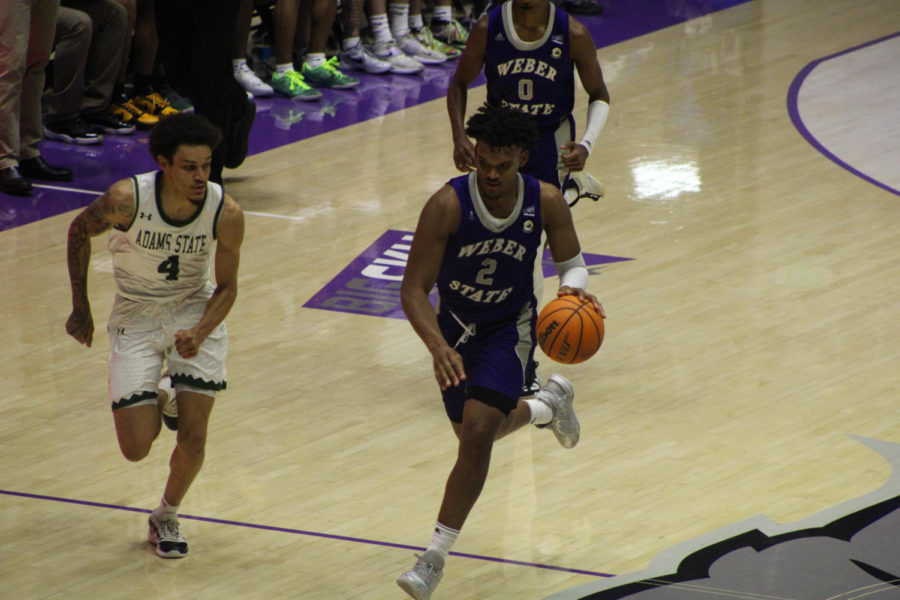 Basketball game against Adams State, taken Nov. 4, 2022. Dillon Jones (2) dribbles down the court.