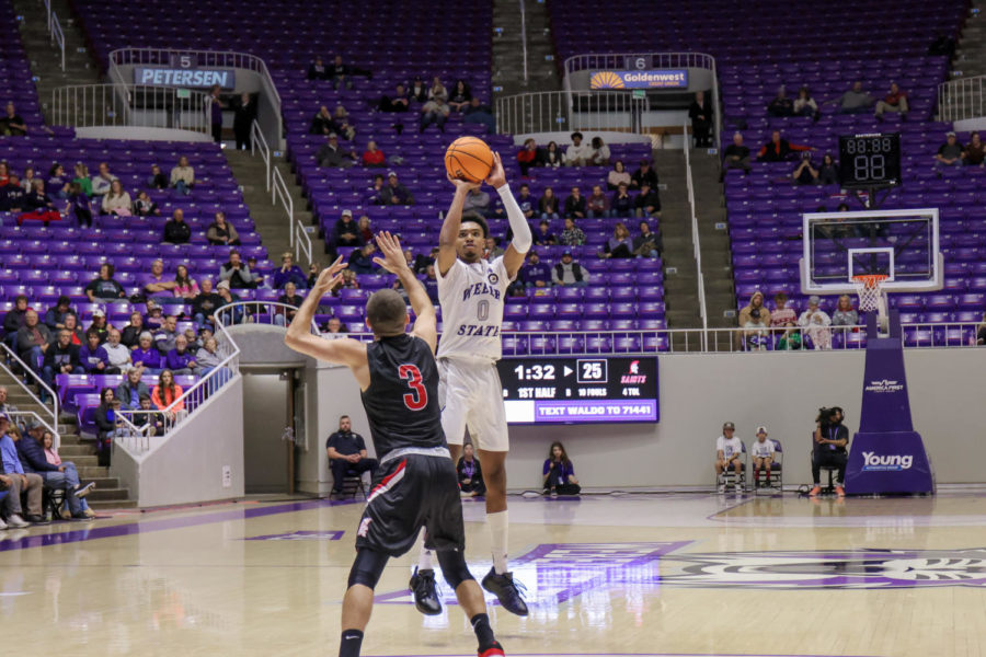 Weber State Guard Zahir Porter shoots a 3-pointer over Saint Martins guard Christian Haffner. The Wildcats shot 50% from the three against Saint Martins.