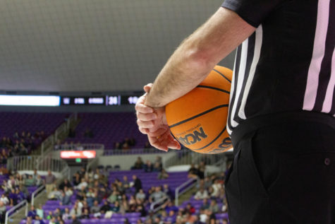 A WSU referee holds a basketball during a game on Jan. 21.