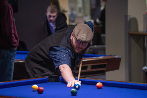 Weber State senior Ryan Davisio, playing pool. His New Years Resolution is to get to the gym more, and get out of the college rut of just staying in to do homework.