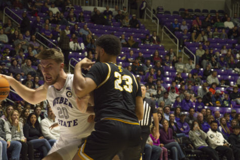 Wildcat center Alex Tew drives inside against Idaho forward John Harge. Tew leads the team in blocks with 14 this season.