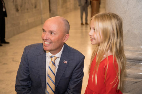 Gov. Spencer Cox posing for a photo with a child during a reception held on Jan. 19, 2023.