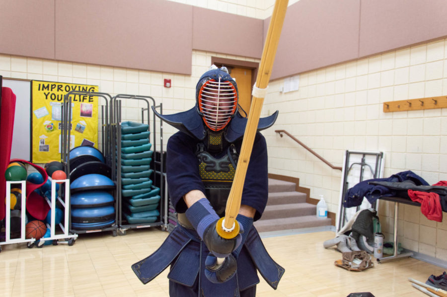 Weber State University student Kolby Doxy in his armor while holding his wooden sword.