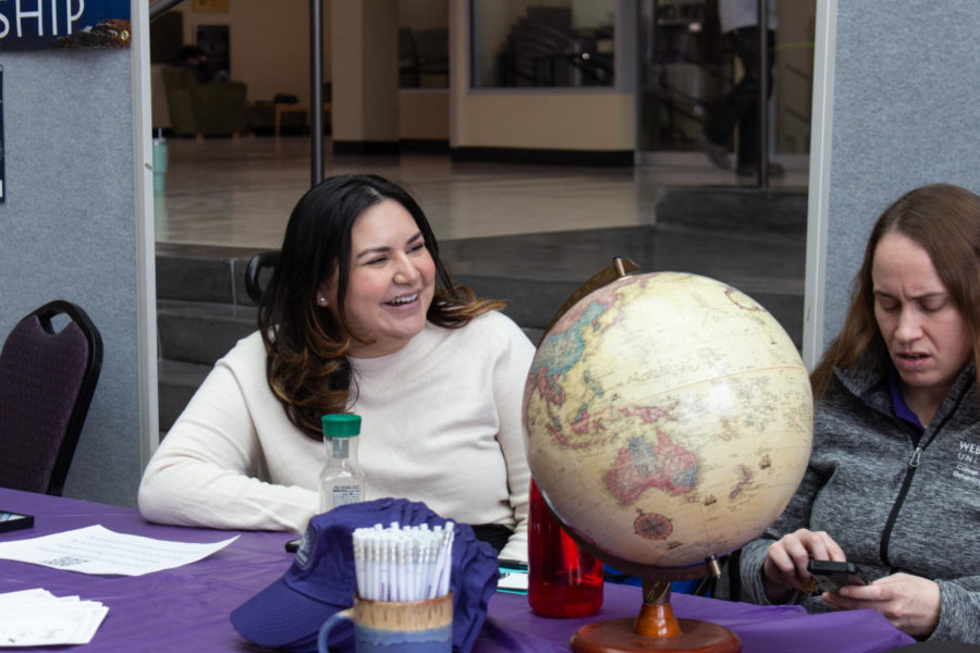 Genesis Vasquez, the academic advisor for the college of social and behavioral science, talking to her co-workers during the Study Abroad fair.
