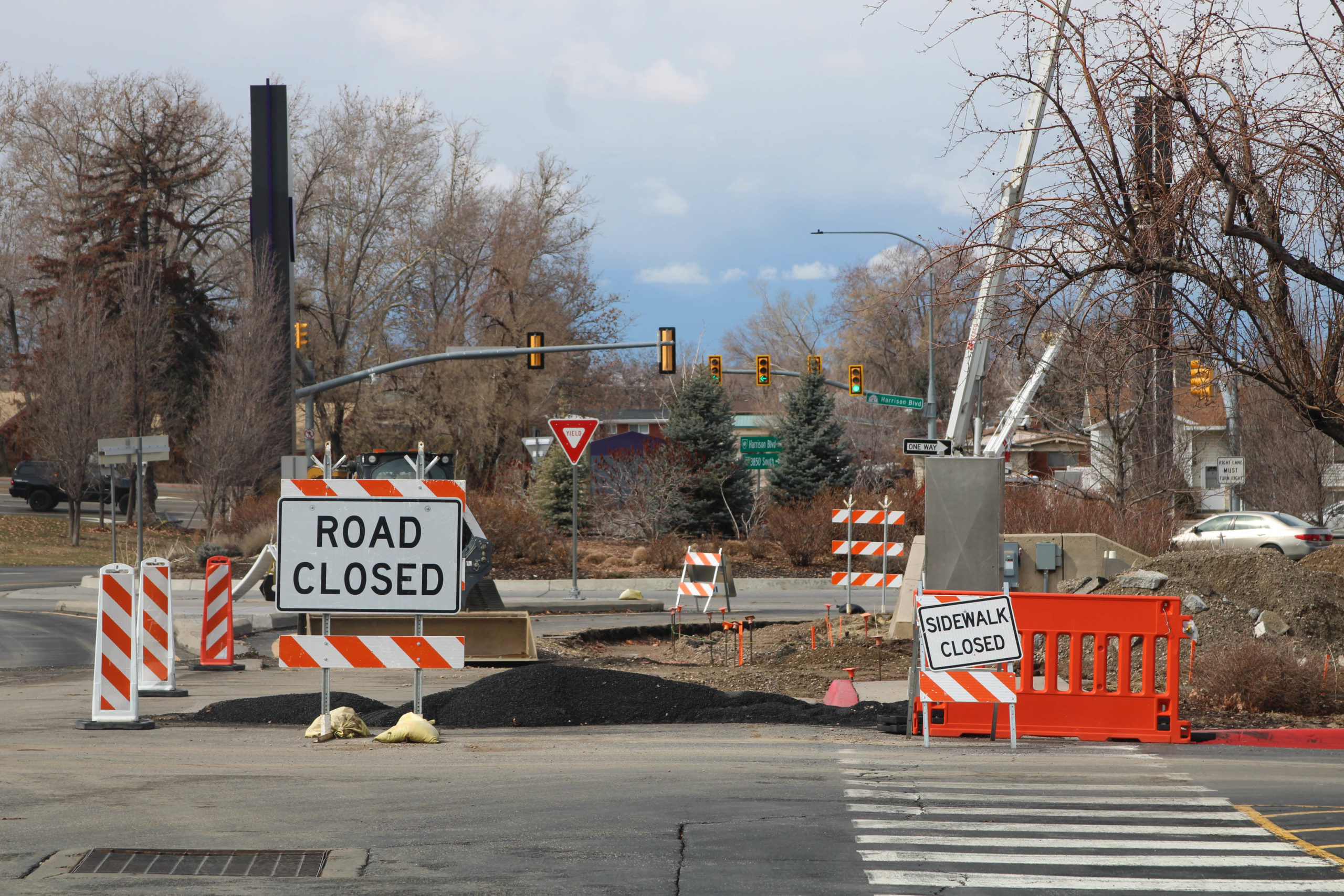 Road Closed and Sidewalk Closed signs blocking off construction zones.