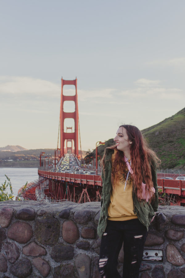 Culture writer Megan Swann stands in front of the Golden Gate Bridge in San Francisco.