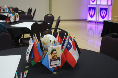 The centerpieces on the tables made with national flags and photos of influential women.