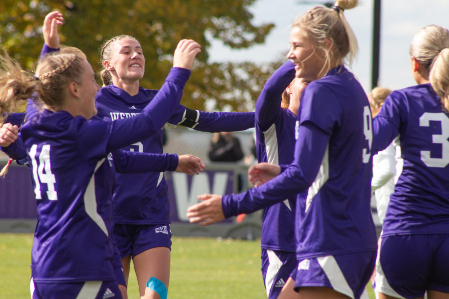 Womens soccer players celebrate a goal made during their game on Oct. 23, 2022.