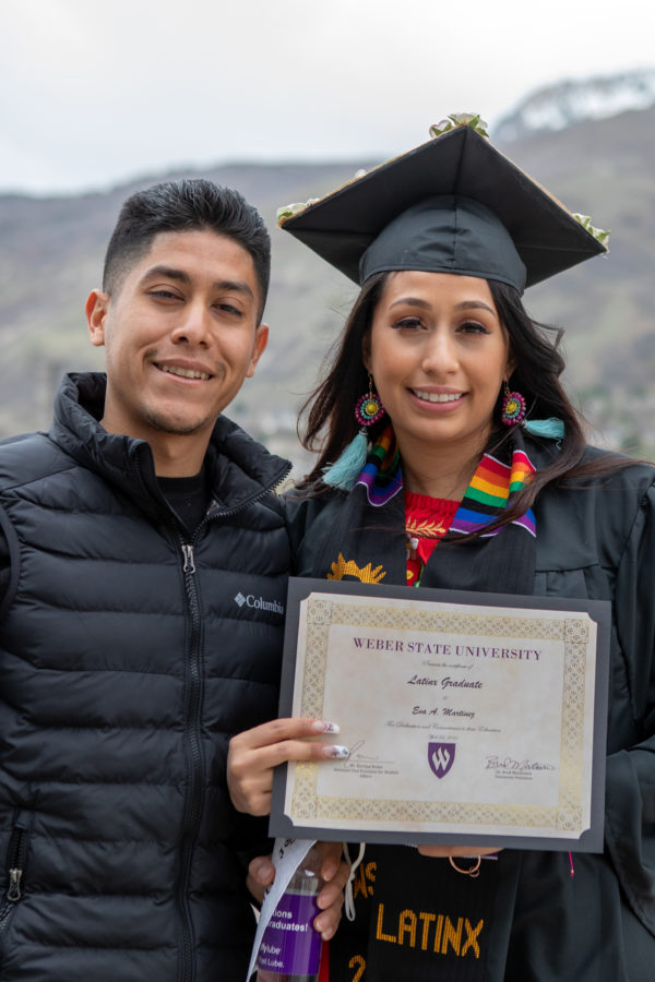 A Weber State graduate with her diploma after the 2021 LatinX graduation ceremony.